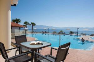 a table and chairs next to a swimming pool at Balos Beach in Kissamos
