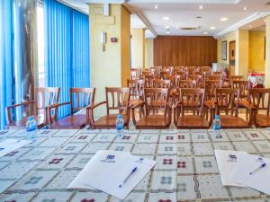 una habitación con sillas y botellas de agua en una mesa en Hotel Legazpi en Murcia