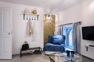 Televízia a/alebo spoločenská miestnosť v ubytovaní Suites 13 Budapest