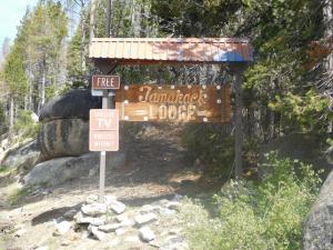 a sign on the side of a trail at The Tamarack Lodge in Lakeshore