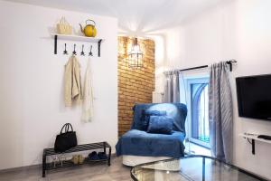 Televízia a/alebo spoločenská miestnosť v ubytovaní Suites 13 Budapest