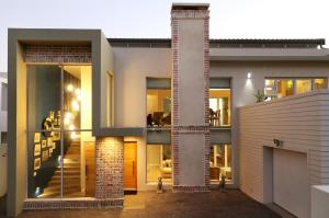 a house with a brick pillar in front of it at Cape Coral in Hermanus