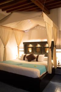 a bedroom with a large bed with a canopy at Hotel & Spa La Mansion del B Azul in Querétaro