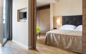 Кровать или кровати в номере Hotel Rossini