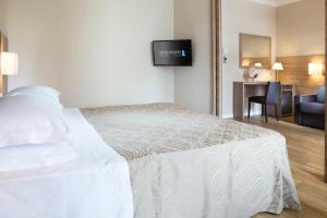 Кровать или кровати в номере Hotel Rossini