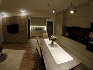 a kitchen and dining room with a table with flowers on it at Heroes' Residence in Budapest