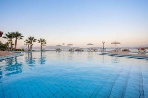 a large swimming pool with a view of the ocean at Balos Beach in Kissamos