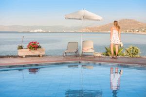 a woman is standing next to a swimming pool at Balos Beach in Kissamos