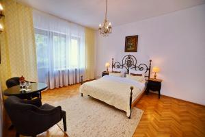 a bedroom with a bed and a table and chairs at Casa Negustorului in Deva