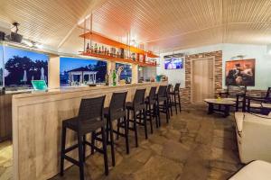 a bar in a restaurant with a bunch of chairs at Sintrivanis Resort Beach in Paralía Skotínis