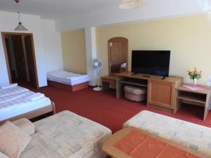 A bed or beds in a room at Penzion Montana