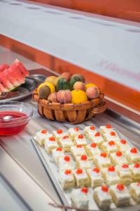 a table with a basket of fruit and a plate of food at Balos Beach in Kissamos
