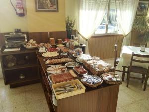 un buffet con muchos tipos diferentes de comida. en Hotel Arboleda en A Lanzada