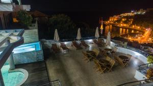 a view of a swimming pool and chairs and a resort at night at Apartments Croma in Ulcinj
