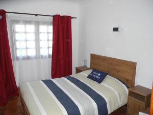 a bedroom with a bed and a window with red curtains at Apartamentos Colombia Ap 5 in Puerto del Carmen +16 photos
