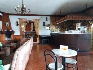 a restaurant with a table and chairs and a counter at RS Sobreiro in Aves