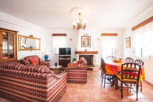 a living room with two couches and a table at Rivers Nation Surf Camp in Atouguia da Baleia