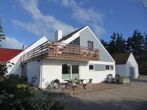 a house with a deck on the side of it at Ferienhaus Rücker in Fehmarn