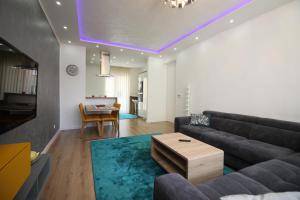 a living room with a couch and a table at Radiceva Apartment in Sarajevo