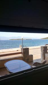 a view of the ocean from a balcony with a tub at Hercules in Amaliapoli