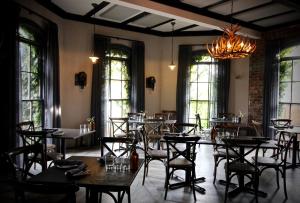 a dining room with tables and chairs and a chandelier at Berida Hotel in Bowral