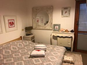 a bedroom with a bed and a mirror at Fregene Summer Beach in Fregene