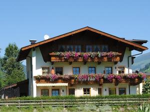 a house with flower boxes on the side of it at Ferienwohnung Rahm in Schwendau