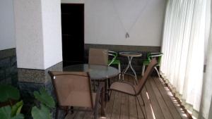 a balcony with a table and chairs on a deck at Lake Villa Homestay in Dongshan