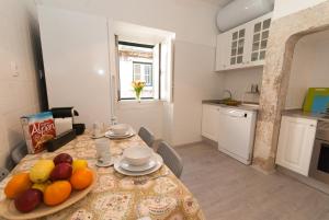 a kitchen with a table with fruit on it at Cosy Baixa Apartment in Lisbon
