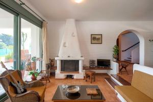 a living room with a fireplace and a couch at Rodos Paradise Villa in Koskinou