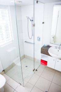 a bathroom with a shower and a sink at 5313 BEACH CLUB CORAL SUITE in Palm Cove