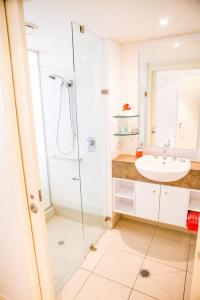 a bathroom with a sink and a shower at 5313 BEACH CLUB CORAL SUITE in Palm Cove