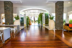 a lobby with a hardwood floor and an archway with plants at 5313 BEACH CLUB CORAL SUITE in Palm Cove