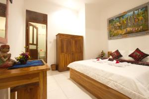 Postel nebo postele na pokoji v ubytování Uma Loris Ubud