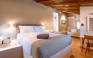 a bedroom with a large bed and a living room at The Secret Boutique Hotel in Lefkada
