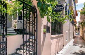 a building with a gate in a street at The Secret Boutique Hotel in Lefkada