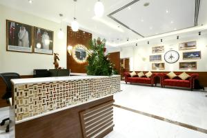 a lobby with red couches and a christmas tree at La Villa Suites Hotel in Doha