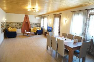 a living room with a table and chairs and a couch at Villa Giota in Potamia