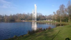 a view of a lake with a monument in the background at B&B Aan het Park Eindhoven in Eindhoven