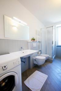 a white bathroom with a sink and a washing machine at Appartamenti Borgo San Pietro in Deiva Marina