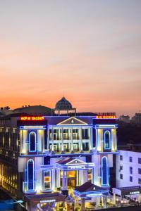 un edificio con luces azules por la noche en Rg Royal Hotel en Bangalore