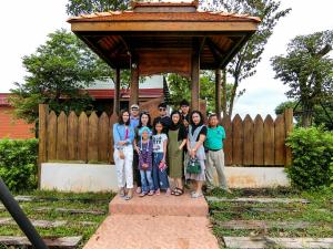 a group of people standing in front of a structure at Mekong Tarawadee Villa in Tha Bo