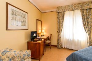 A bed or beds in a room at Albergo Reggio