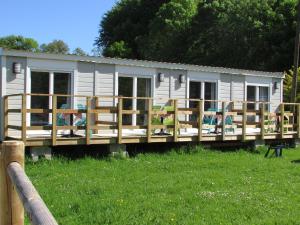 a mobile home with a deck in the grass at Etretat's Motel in Étretat +4 photos