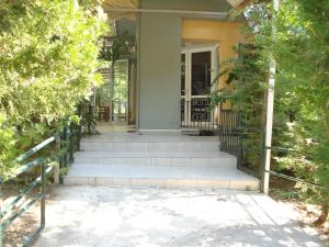a house with stairs leading to a door at Hotel Cybele Pefki in Athens