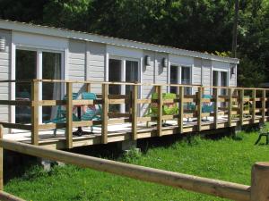 a mobile home with a porch and a fence at Etretat's Motel in Étretat