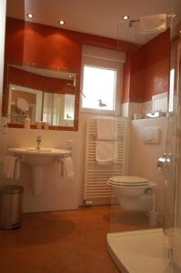 a bathroom with a toilet and a sink at Ferien-Wein-Gut Keifer in Bernkastel-Kues