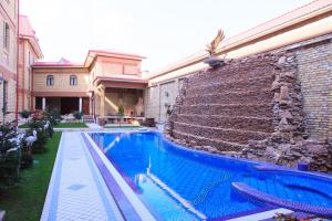 a swimming pool in front of a building at Rakat Plaza in Tashkent