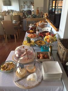 a table with many plates of food on it at Hotel Santa Maria in Saint-Florent