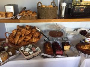 a shelf with different types of bread and pastries at Hotel Santa Maria in Saint-Florent